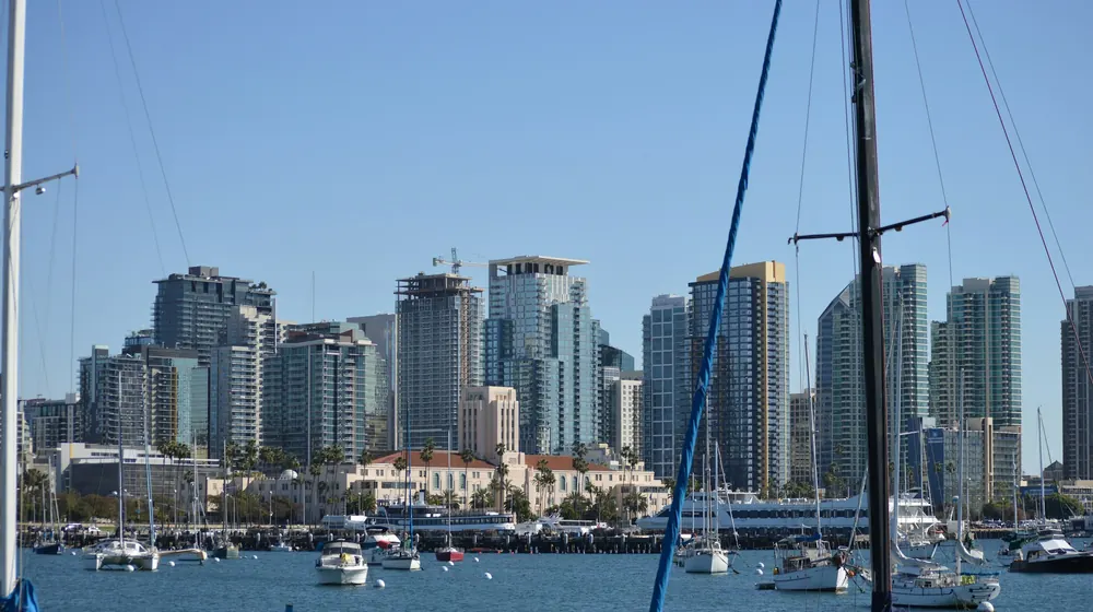 Downtown San Diego high-rises seen across the bay past moored sailboats