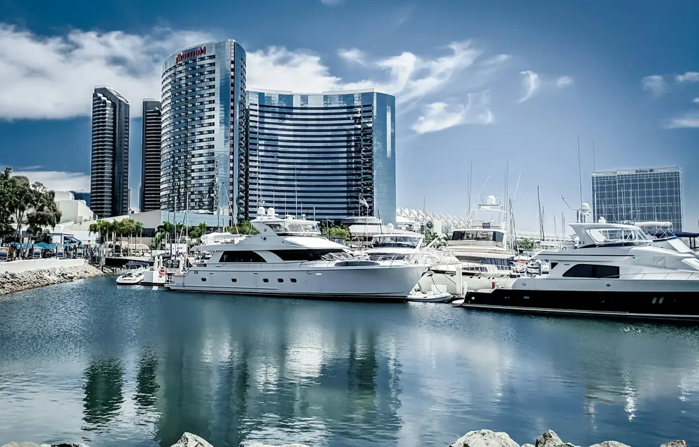 Yachts moored on the downtown San Diego waterfront below hotel and condo towers